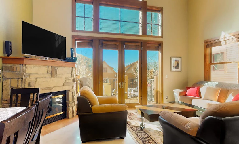 Centrally located with balcony, fireplace, heated garage parking & ski locker