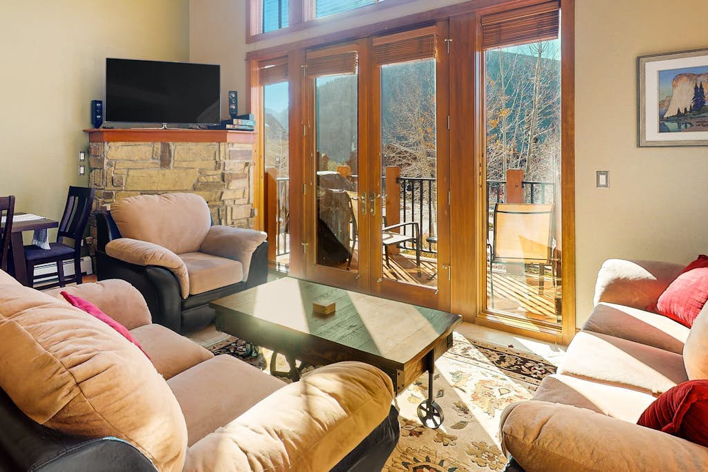 Centrally located with balcony, fireplace, heated garage parking & ski locker