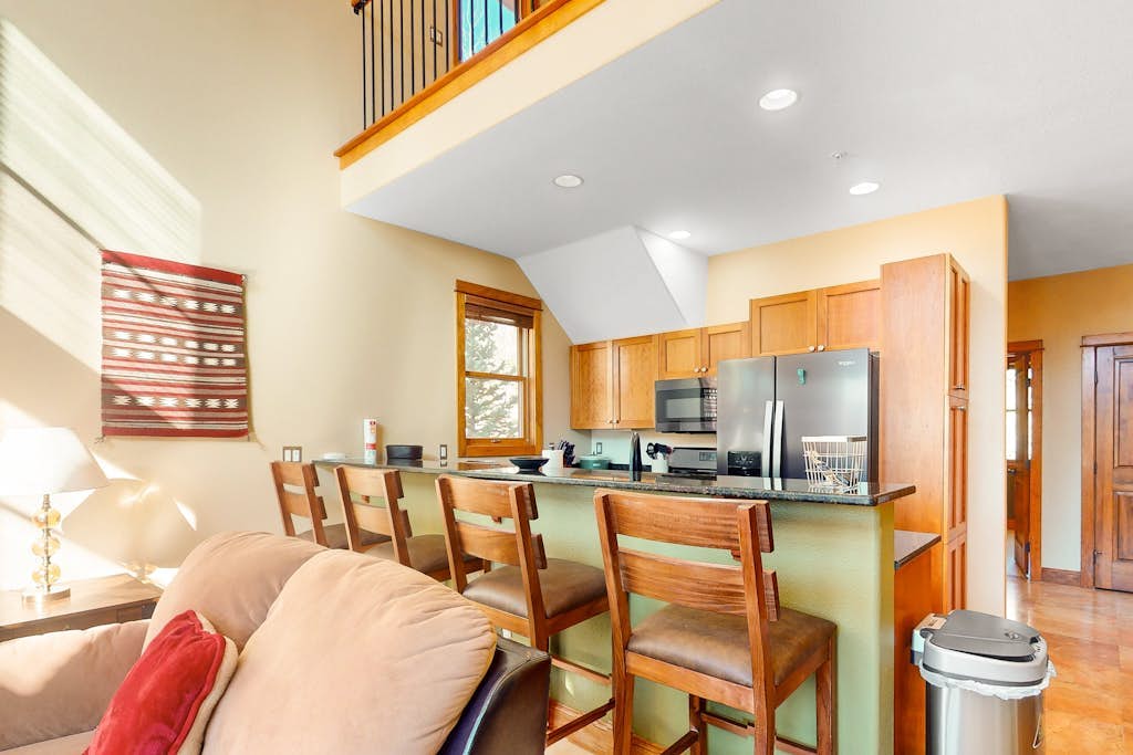 Centrally located with balcony, fireplace, heated garage parking & ski locker