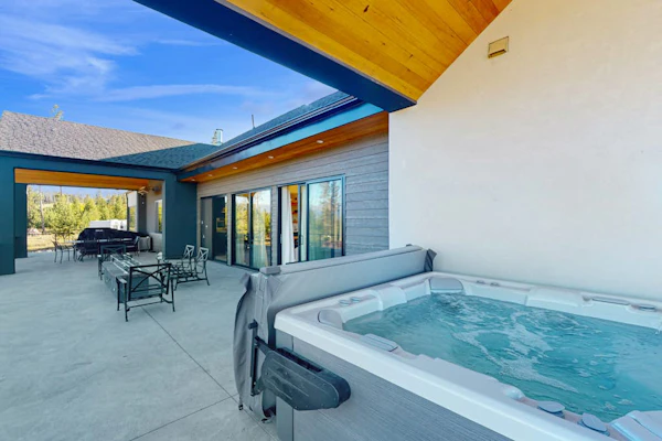 Modern home with a hot tub, game room and fabulous deck space!