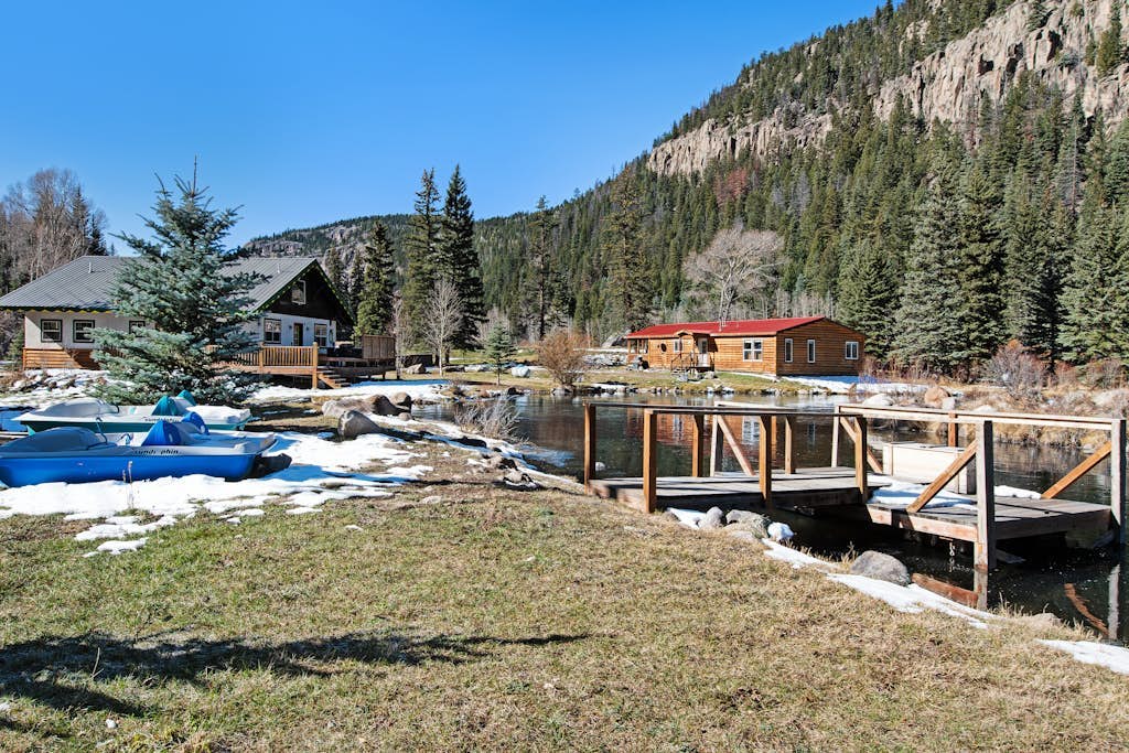 Waterfront cabin with mountain view, wood stove, private hot tub, & WiFi