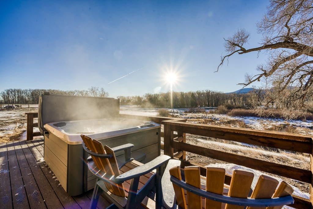 Dog-friendly riverfront retreat with hot tub, stunning views & screened porch