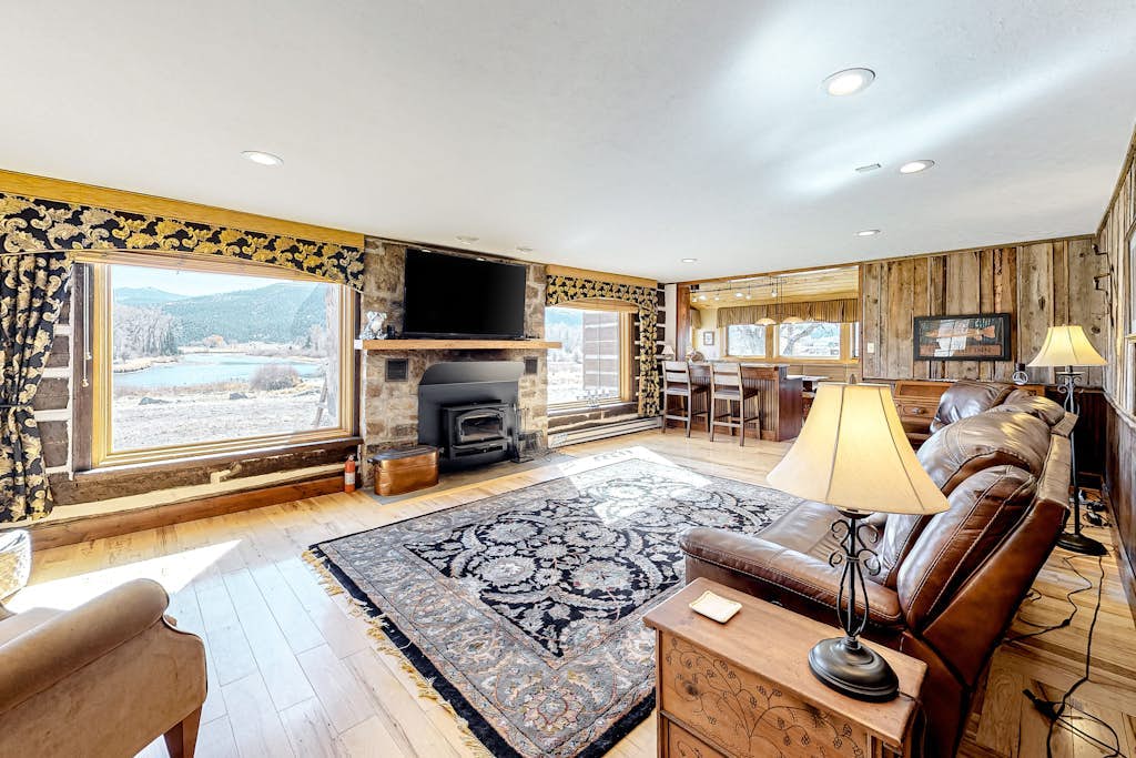 Dog-friendly riverfront retreat with hot tub, stunning views & screened porch