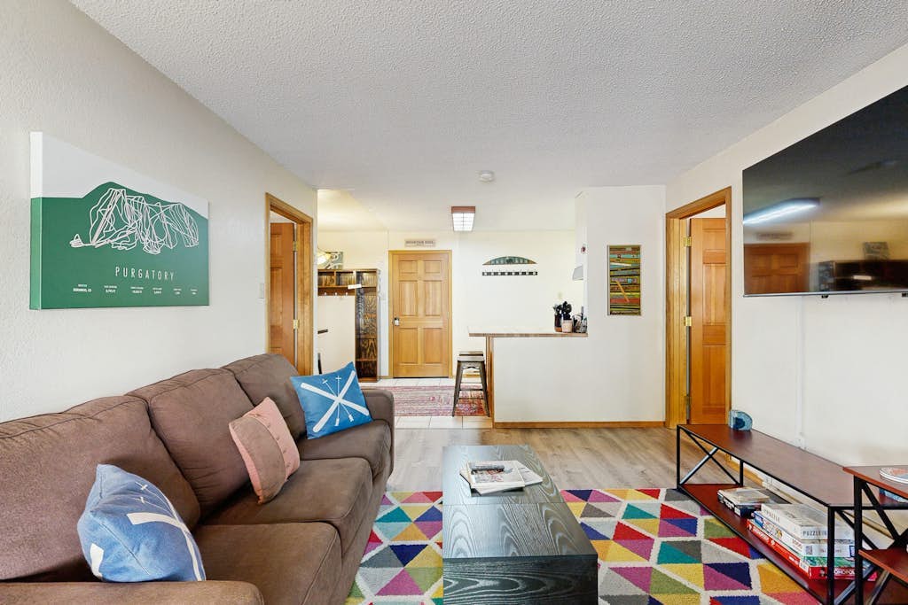 Mountain condo with a wood burning stove, shared hot tub, and steps to ski lift