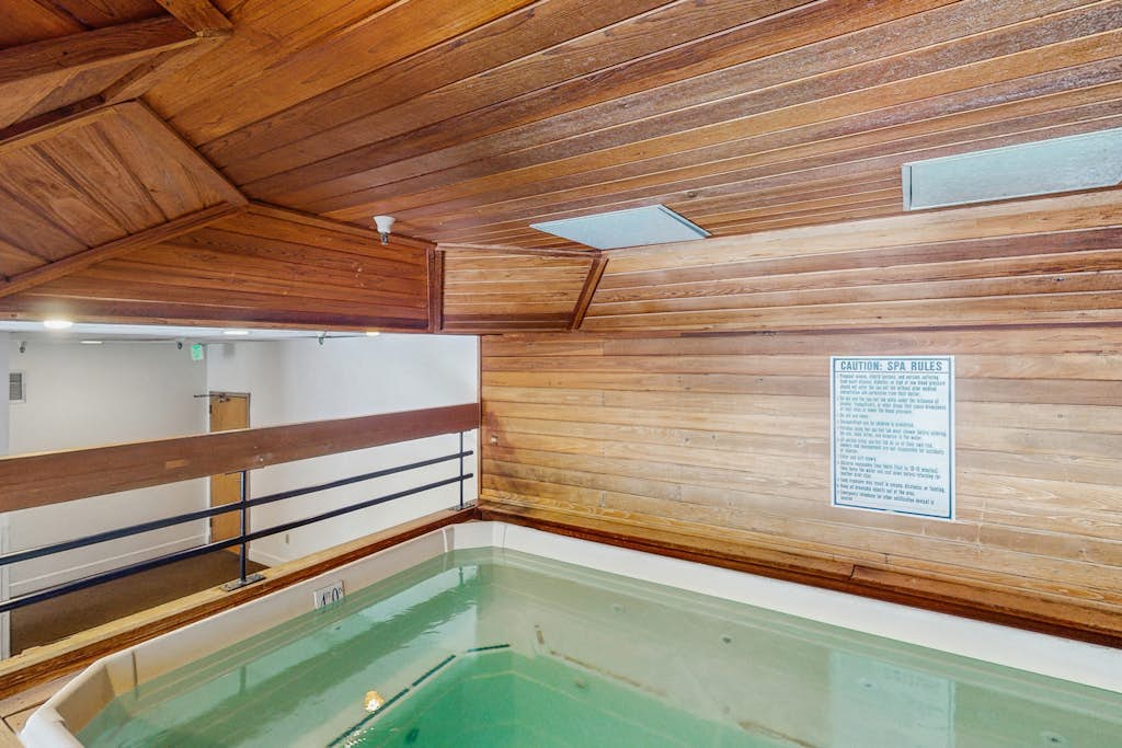 Charming condo with a private sunroom, kitchen, & hot tub - walk to lift
