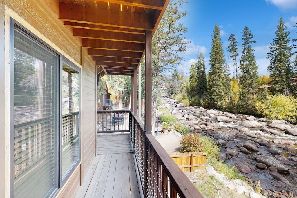 Riverfront, mountain-view retreat with a full kitchen and fireplace