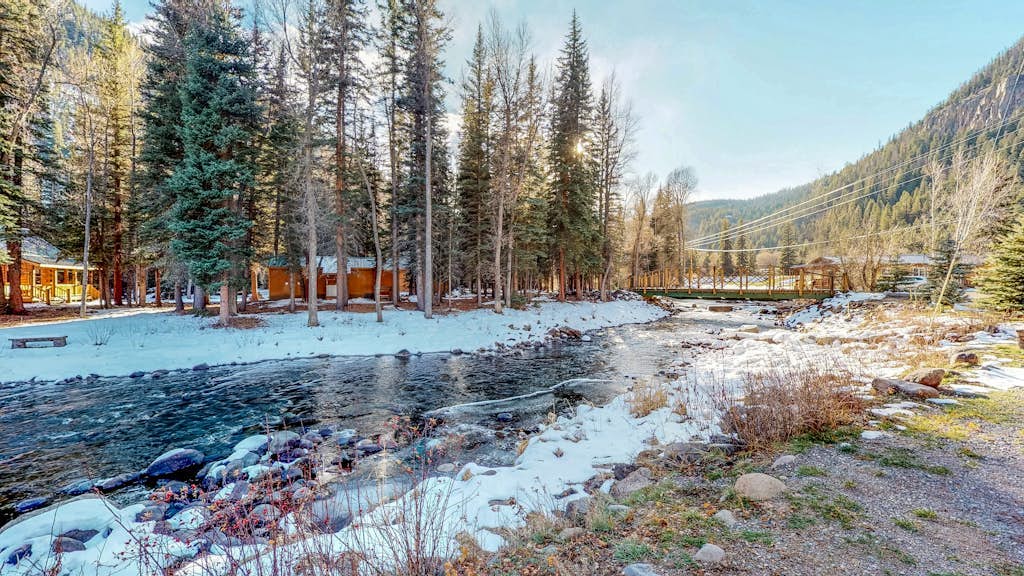 Dog-friendly cabin with wood stove, private hot tub, & riverside firepit