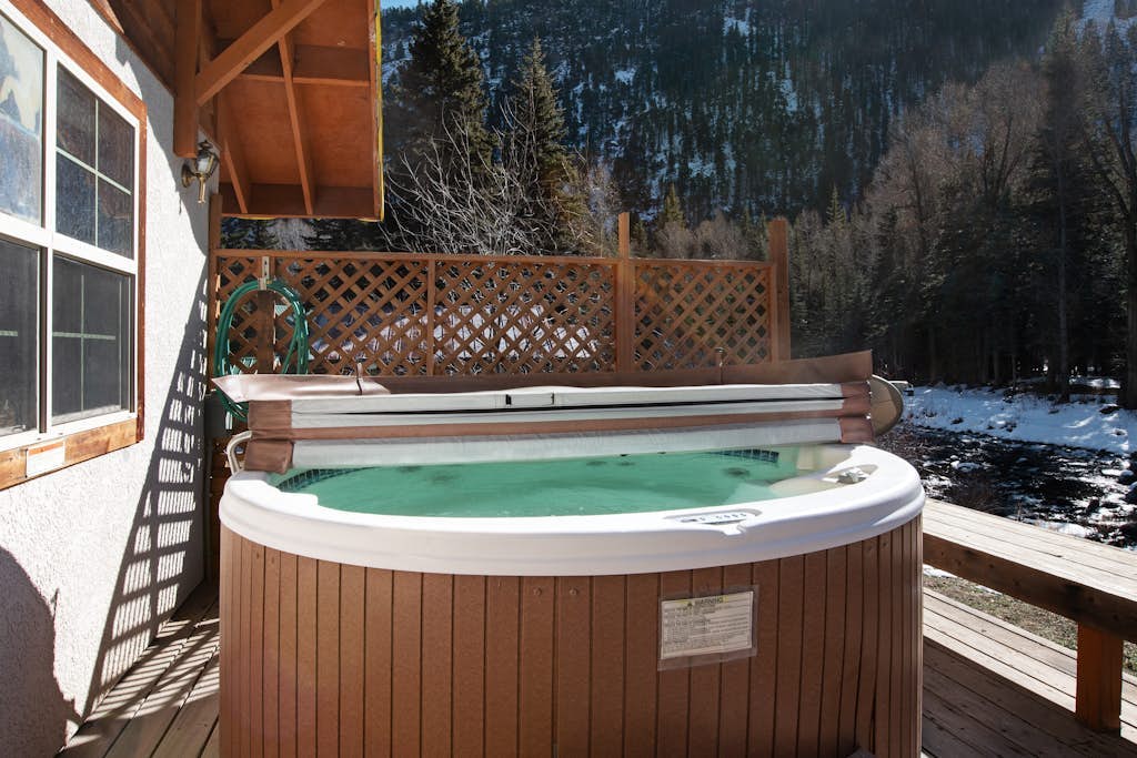 Dog-friendly cabin with wood stove, private hot tub, & riverside firepit