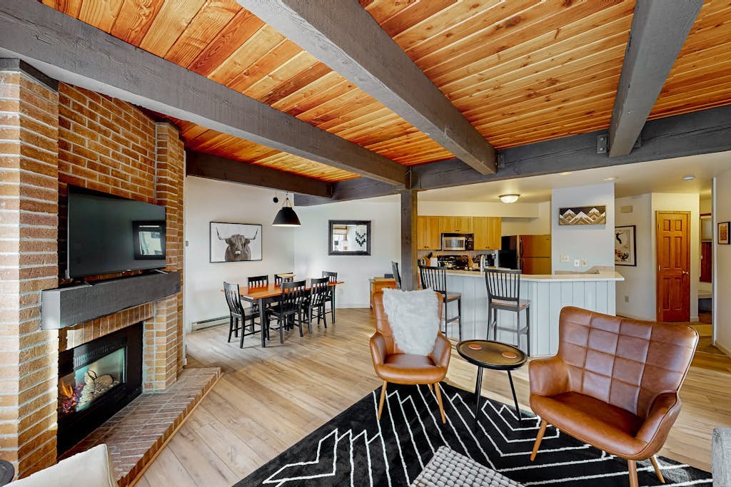 Slopeside condo with pool, hot tubs, ski shuttle, fireplace, & deck