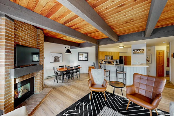 Slopeside condo with pool, hot tubs, ski shuttle, fireplace, & deck