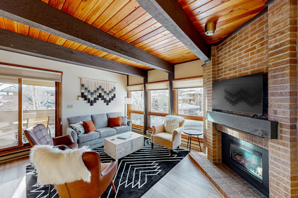 Slopeside condo with pool, hot tubs, ski shuttle, fireplace, & deck