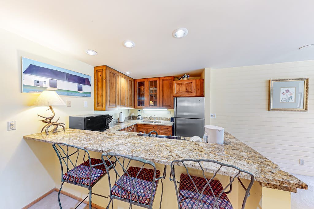 Rustic condo with resort amenities, sweeping views, and wood-burning fireplace