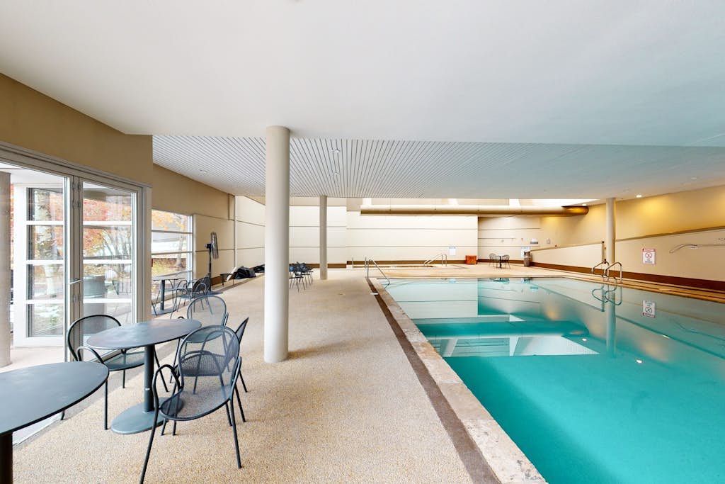 Rustic condo with resort amenities, sweeping views, and wood-burning fireplace