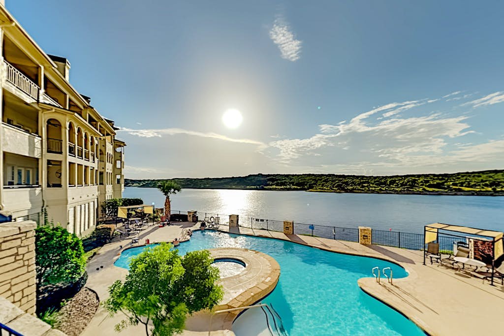 Lavish lakefront retreat in private island community with pools, tennis, & gym
