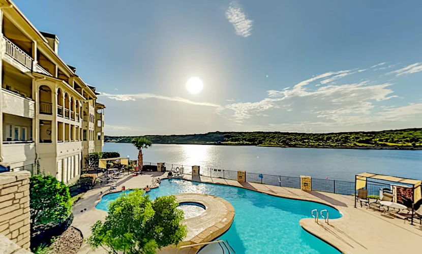 Lavish lakefront retreat in private island community with pools, tennis, & gym
