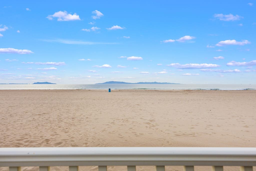 Beachfront abode with spacious deck, pool table, gas grill, smart TVs, & W/D