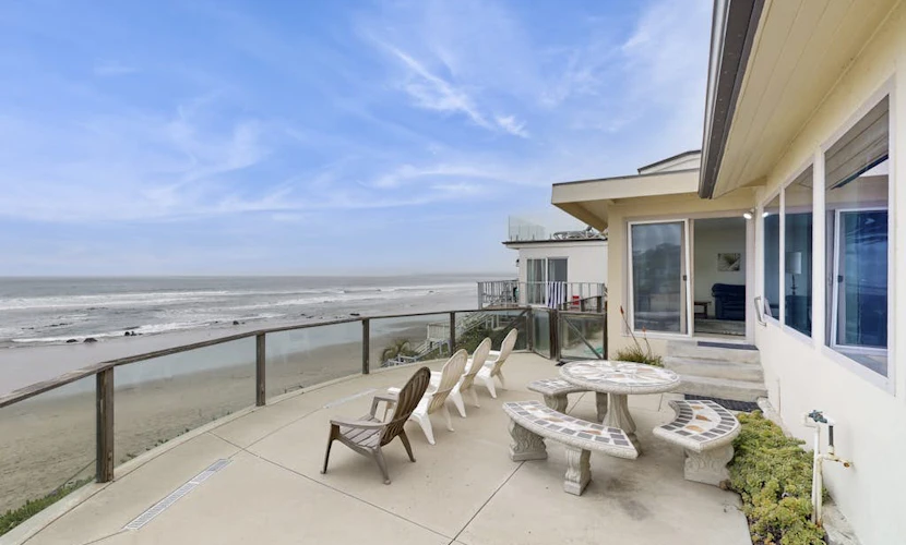 Classic waterfront beach house with a furnished deck & ocean views