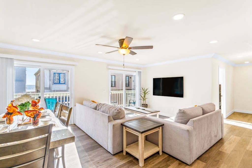 Dog-friendly 2nd-floor duplex near beach with balcony, sunroom, W/D & streaming