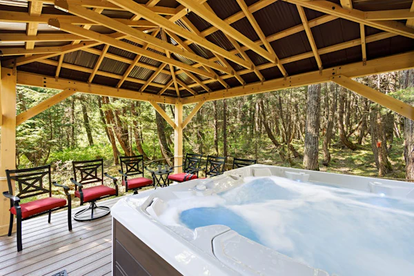 Ullr is the Norse god of snow, and his treehouse is exactly what it sounds like—a highly unique, 1,400 sq. ft. hexagonal cabin that climbs straight up into the spruce canopy across four distinct, 350 sq. ft. levels. Bordering Chugach State Park land, the back path connects you to Beaver Pond Trail for foot treks into town. The layout rises into the trees to offer intimate, custom spaces: a basement media room with a PS4, a second-floor leather lounge and compact kitchen, and a lofted primary bedroom under sloped timbers. Outside, a massive hot tub waits beneath the old-growth tree canopy. *Just be ready to summon your inner mountain goat for the four flights of stairs.* Standard Specs: Full compact kitchen, outdoor hot tub, gas fireplace, private washer/dryer, PS4 console, flat-screen TVs, high-speed WiFi, and keypad entry. Driveway parking for up to four vehicles. On the Glacier Valley Transit route. Sleeps 6.