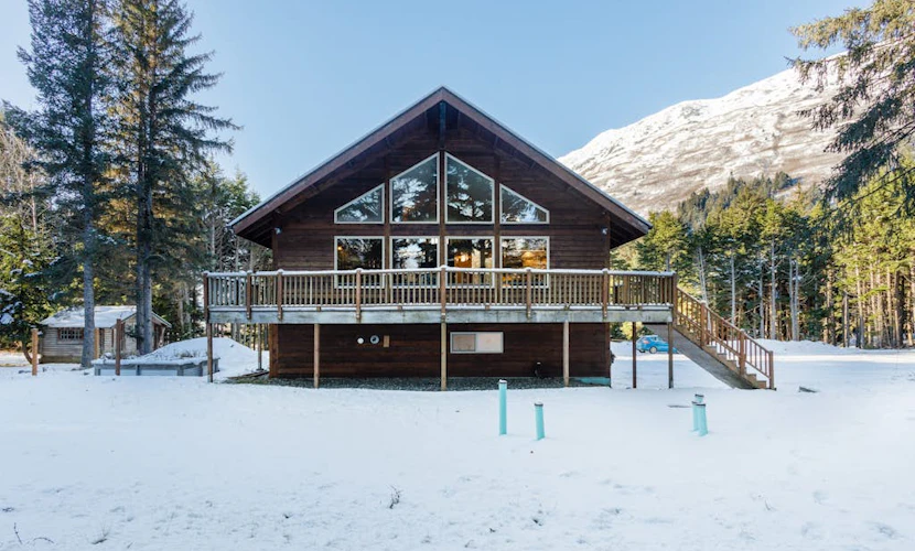 The independent lower-level residence of the Monarch Mine estate—a beautifully updated three-bedroom duplex suite that accommodates up to six guests with complete comfort and privacy. The layout features a private ground-floor entrance, a fully equipped kitchen, and a cozy living area built for winding down after Alaskan backcountry trail runs. Walk straight out to the large lot, fire up the grill, or take a 5-minute walk to the Great Alaska Railroad Girdwood Depot for effortless regional transit. Offers the exact same premium Bird-to-Gird trail path and Alyeska Resort access as the upper unit at a smaller scale. *Please note: As a lower-level duplex suite, you may occasionally hear footsteps from the upper unit.* Standard Specs: Fully equipped kitchen, private ground-floor entrance, private mountain-view patio, flat-screen TV with streaming access, high-speed WiFi, and keypad entry. Lower duplex layout. Driveway parking for up to four vehicles. Sleeps 6.
