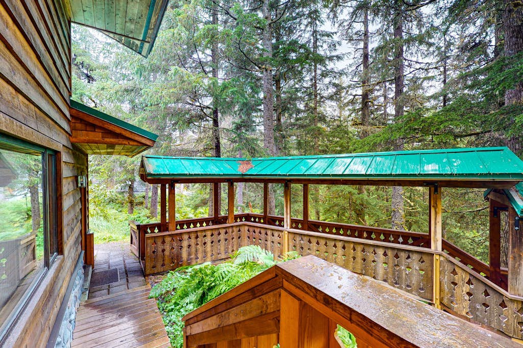 The full St. Moritz property combines a sprawling three-story main residence and an adjoining studio apartment into a single hillside compound—offering the perfect multi-generation layout for groups who want to stay under one roof without piling on top of each other. Located a quiet mile from Alyeska Resort, the estate features two independent full kitchens, two living rooms, an authentic wood stove, and a private jetted soaking tub. Large windows and a third-floor observation balcony capture clear views of old-growth timber and valley peaks. *Winter notice: The hillside location means 4x4 vehicles are strictly required during snowy months.* Standard Specs: Two full kitchens, private laundry, wood stoves, jetted tub, flat-screen TVs, high-speed WiFi, and keypad entry. Driveway parking for two vehicles (street parking available). Includes comprehensive damage waiver. No A/C. Sleeps 10.