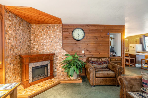 One block from the ski lifts. That is the entire operational pitch for this peaceful apartment suite, tucked privately above the garage of a detached home in a quiet pocket of Girdwood. With Girdwood’s paved multi-use bike path running directly past the front door, hopping between the slopes, the summer hiking trailheads, and the village center requires zero driving logistics. The clean interior features a well-equipped kitchen, reliable high-speed WiFi for mountain remote work, and accessible mountain views right from the windows. Standard Specs: Well-equipped kitchen, flat-screen TV, high-speed WiFi, and keypad entry. Dedicated parking for one vehicle. Attached unit with private entry. Sleeps 3.