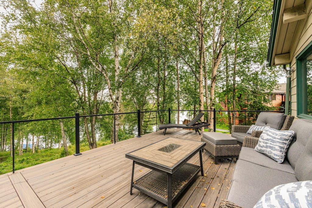 The kind of high-end Anchorage estate that anchors an entire multi-generation vacation or corporate campaign. Perched on a private lot on the shores of Sand Lake, this massive 4,500-square-foot home sits just minutes from the airport and four miles from Kincaid Park, while providing a clean highway shot down to the Girdwood valley. The property features a private boat dock on the water, provided stand-up paddleboards (SUPs), and a waterfront hammock, while turning into a cross-country ski loop in the winter. Inside, discovery awaits with two gas fireplaces, an exercise room, an air hockey table, a master jetted soaking tub, and a limited-mobility accessible ground-floor suite with its own independent kitchen and bath. Standard Specs: Two full kitchens, two gas fireplaces, private boat dock, stand-up paddleboards, indoor exercise room, air hockey table, master jetted tub, private laundry, flat-screen TVs, high-speed WiFi, and keypad entry. Parking for three vehicles. Sleeps 10.