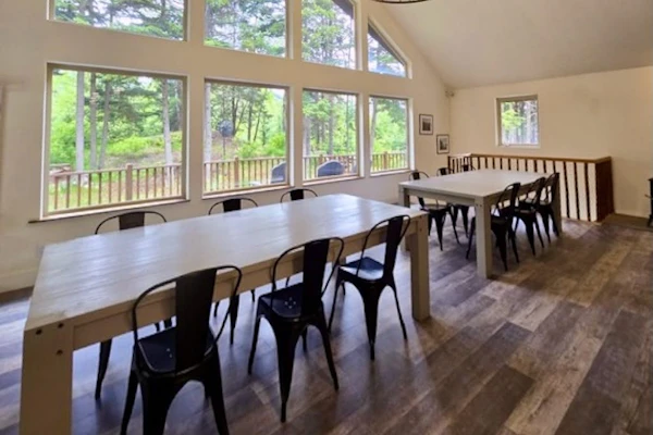 The premium upper-level residence of the Monarch Mine estate—a newly remodeled six-bedroom plus loft duplex layout that comfortably accommodates up to fifteen guests with exceptional space, high vaulted ceilings, and modern structural finishes. Large windows flood the interior with natural light and frame crisp views of the surrounding peaks, while a massive, fully equipped kitchen handles large-scale group meals effortlessly. Step out onto the expansive private deck that runs the length of the home for morning coffee, or drop directly onto the Bird-to-Gird biking path right outside your door. Less than a 12-minute walk to coffee, pizza, and fuel at Girdwood Station. Standard Specs: Large fully equipped kitchen, expansive private deck, flat-screen TVs with streaming access, high-speed WiFi, premium bedding, and keypad entry. Upper duplex layout. Driveway parking for up to six vehicles. 5-minute walk to Girdwood Train Depot. Sleeps 15.