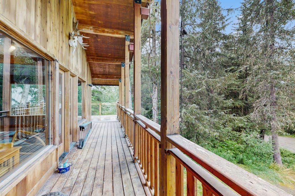 The kind of Girdwood home that completely earns the word welcoming—offering a warm, timber-accented open layout, comfortable bedrooms, and a fully equipped kitchen built for hosting dinners with friends at the end of a long trail day. Step out onto the private forested deck to unwind under the stars in your luxury outdoor hot tub, or stoke the fireplace inside. Positioned just a few minutes from the chairlifts at Alyeska Resort, the home sits within easy walking distance of the Alyeska Nordic Spa, the Double Musky Inn, and Girdwood Brewing Company. Dogs are welcome to join. Standard Specs: Fully equipped kitchen, private outdoor hot tub, fireplace, flat-screen TV, high-speed WiFi, and keypad entry. Driveway parking for two vehicles. Dog-friendly. Sleeps 7.