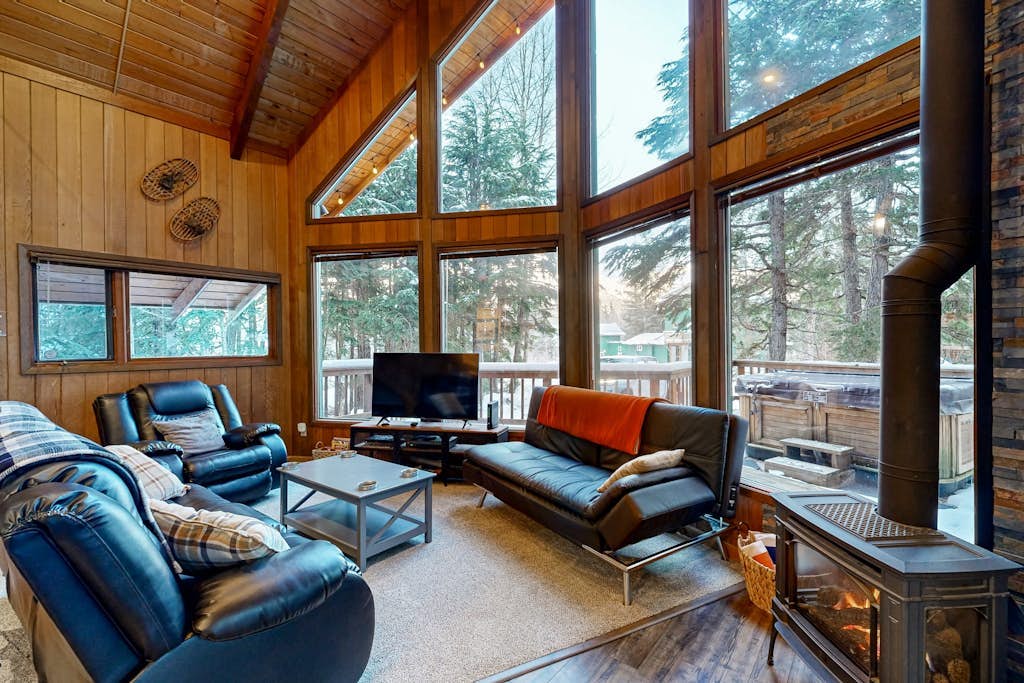 Some properties are styled to look like old Girdwood. This one actually is Girdwood. Preserving the architectural culture of the valley's early ski days, this classic A-frame chalet features original open-beam wood interiors, towering windows, and an open floor plan that lets the mountain light all the way in. Modern updates are placed thoughtfully where they matter most—including a reliable gas heating stove and a traditional, wood-powered cedar barrel sauna right outside the front door to handle muscle recovery. Located in an established neighborhood close to the hill, it sits directly on the paved path running toward Virgin Creek Falls trailhead. Standard Specs: Full kitchen with dishwasher, private washer/dryer, flat-screen TV, high-speed WiFi, and keypad entry. Dedicated parking for two vehicles. Guests can easily purchase firewood for the sauna locally. Sleeps 5.