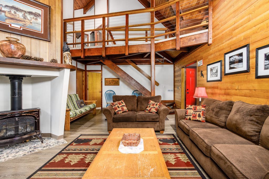 Big timber beams, soaring vaulted ceilings, and a private hot tub waiting under the spruce canopy—Vail Chalet delivers an authentic lodge-style retreat. Located a short walk from Girdwood’s trailheads and a brief drive to Alyeska Resort, the home looks out over the mountain lights in the winter and wild berry patches in the summer. The interior has been completely updated to meet modern standards, featuring a premium kitchen with a new LG refrigerator, fresh furnishings, and a primary bedroom suite with its own private gas fireplace. A second fireplace anchors the main living room, offering a warm sanctuary for groups and their dogs. Standard Specs: Fully equipped kitchen, private outdoor hot tub, two fireplaces, propane grill, private washer/dryer, cable TV/DVD, high-speed WiFi, and keypad entry. Parking for two vehicles. Dog-friendly. Sleeps 8.