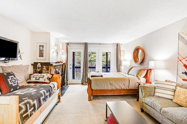 A crisp, practical studio condo positioned a short walk from the Alyeska chairlifts in central Girdwood, making it the ideal basecamp for travelers who would rather spend their time exploring the mountain than sitting inside a room. The floor plan focuses entirely on utility, offering a private balcony for morning mountain views, a well-equipped kitchen with a full dishwasher, and immediate access to the building's deep-heat shared sauna to flush out the miles after a long day on the snow. Walking distance to the village's best restaurants, art galleries, and grocery loops. Standard Specs: Well-equipped kitchen with dishwasher, private balcony, flat-screen cable TV, high-speed WiFi, keypad entry, and shared building sauna. Parking for one vehicle. Fireplace is decorative/non-operational. No A/C. Sleeps 4.