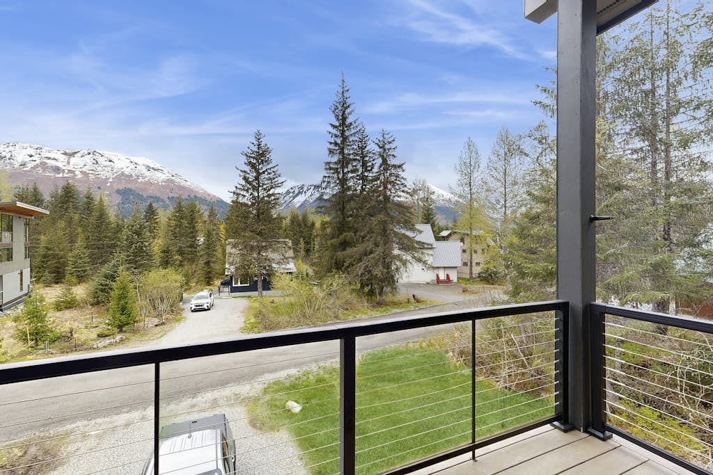 Constructed brand new in 2021 with sharp contemporary finishes and expansive viewing windows that frame the surrounding Chugach peaks, Glacier View Getaway makes a powerful case for the modern Girdwood home. Built specifically for large family groups and outdoor teams who want space without losing a classic mountain feel, the four-bedroom house features an open-concept kitchen built for real cooking and a massive, dedicated lower-level game room equipped with a custom foosball table. Positioned just minutes from Alyeska Resort, Girdwood Brewing Company, and local trailheads. Standard Specs: Gourmet full kitchen, private lower-level game room with foosball, contemporary finishes, large-capacity windows, flat-screen TV, high-speed WiFi, and keypad entry. Driveway parking for two vehicles. Sleeps 11.