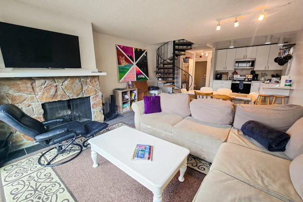 A short walk from the Alyeska lifts, this Girdwood condo trades the logistics for ease — clip in near the door, ski back when your legs are done, and let the rest of the day sort itself out. The living room is built for the wind-down, warmed by a fireplace, with a balcony that frames the surrounding peaks and a full kitchen ready for cooking in rather than heading back out. Two king beds suit two couples or a small family, and the combination tub/shower is a welcome thing after a cold day on the snow. Downhill terrain and Nordic tracks both sit within reach, and when the snow goes the same country opens up for hiking, mountain biking, and bird and wildlife watching, with the resort spa and village dining close by. Standard Specs: Full kitchen, two king beds, fireplace, private balcony, combination tub/shower, high-speed WiFi, and cable TV/DVD. No air-conditioning. Free parking for two vehicles. Sleeps 4.