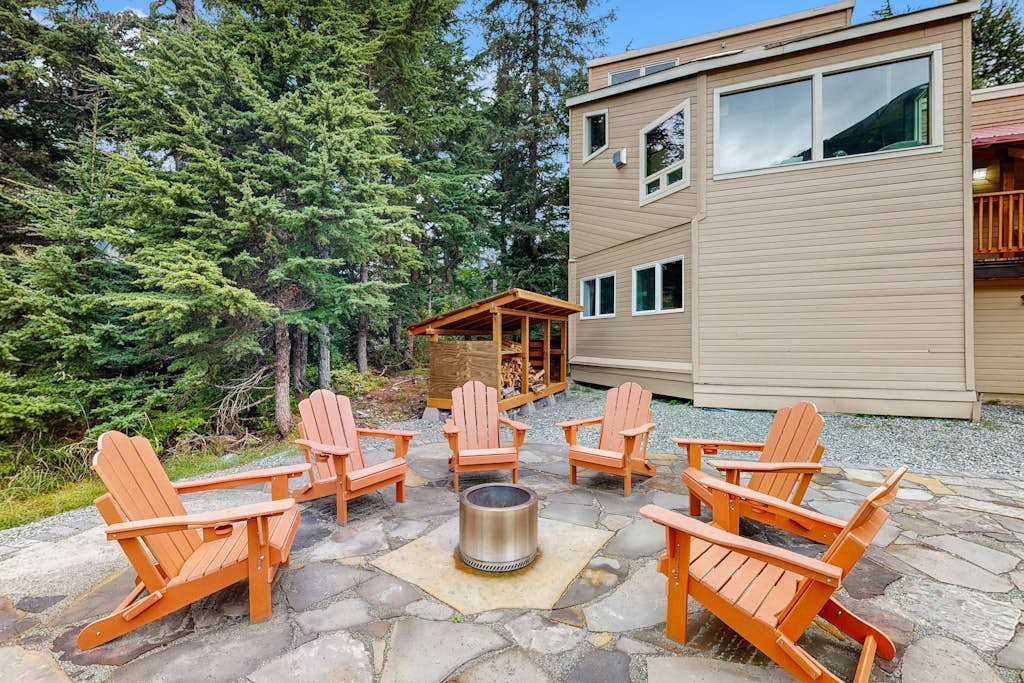 Sprawling across four distinct structural floors and completely enclosed by a serene, old-growth spruce forest, Vail Meadows Chalet is the ultimate four-season mountain basecamp. Located a short half-mile walk from world-famous Alyeska Resort, this commanding home handles large group campaigns with total ease. Winter trips focus around an authentic wood stove, an indoor private dry sauna, and direct slope access for fat-tire biking or skiing. Long summer days center around a private stone patio and fire pit with completely unobstructed mountain views, surrounded by high-bush blueberry and salmonberry bushes. Features a cozy loft, multiple king suites, a custom bunk room, and children's amenities. Standard Specs: Fully equipped kitchen, private indoor dry sauna, outdoor stone patio with fire pit, wood stove, covered viewing deck, child's high chair/Pack-N-Play, Smart TV, board games, high-speed WiFi, and keypad entry. Driveway parking for three vehicles on a quiet cul-de-sac. Sleeps 8.