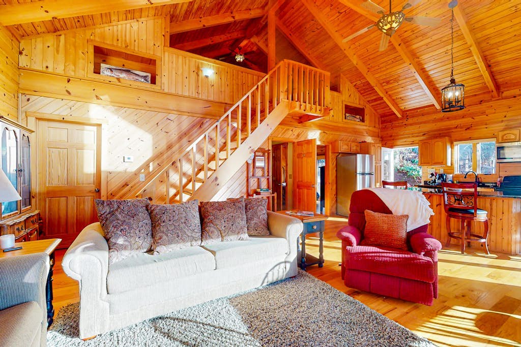Rustic two-story lakefront cabin near beach with dock, lake & mtn views, & deck