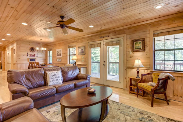 Pond-front cabin with private hot tub, fireplaces, furnished deck, & game room