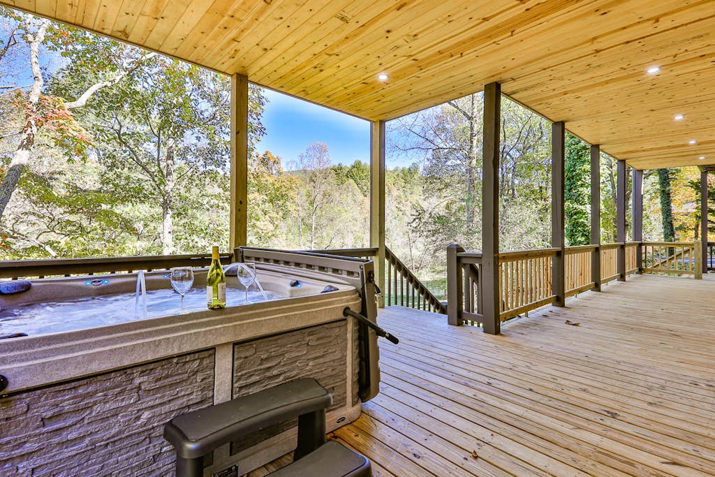 Homey riverfront cabin with hot tub, grill, wood fireplace, AC, & scenic views