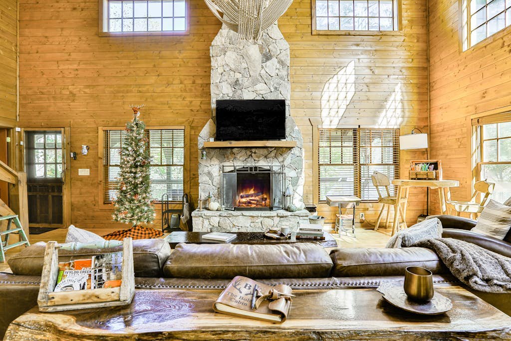Homey riverfront cabin with hot tub, grill, wood fireplace, AC, & scenic views