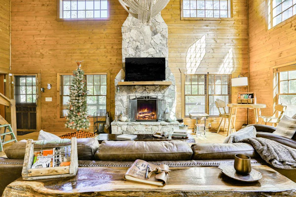 Homey riverfront cabin with hot tub, grill, wood fireplace, AC, & scenic views