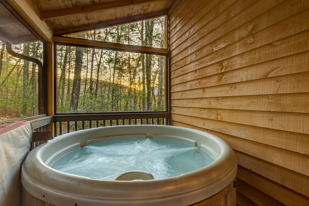Peaceful dog-friendly cabin with private hot tub, firepit, & deck