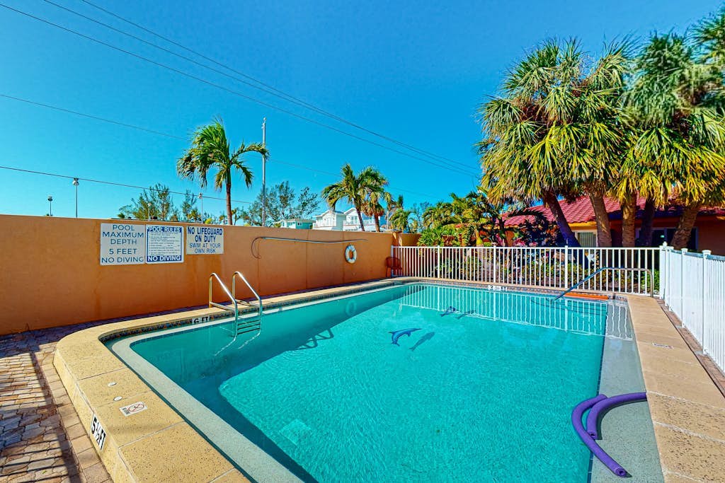Ground-floor home with fast WiFi, shared pool, & central AC - close to beach