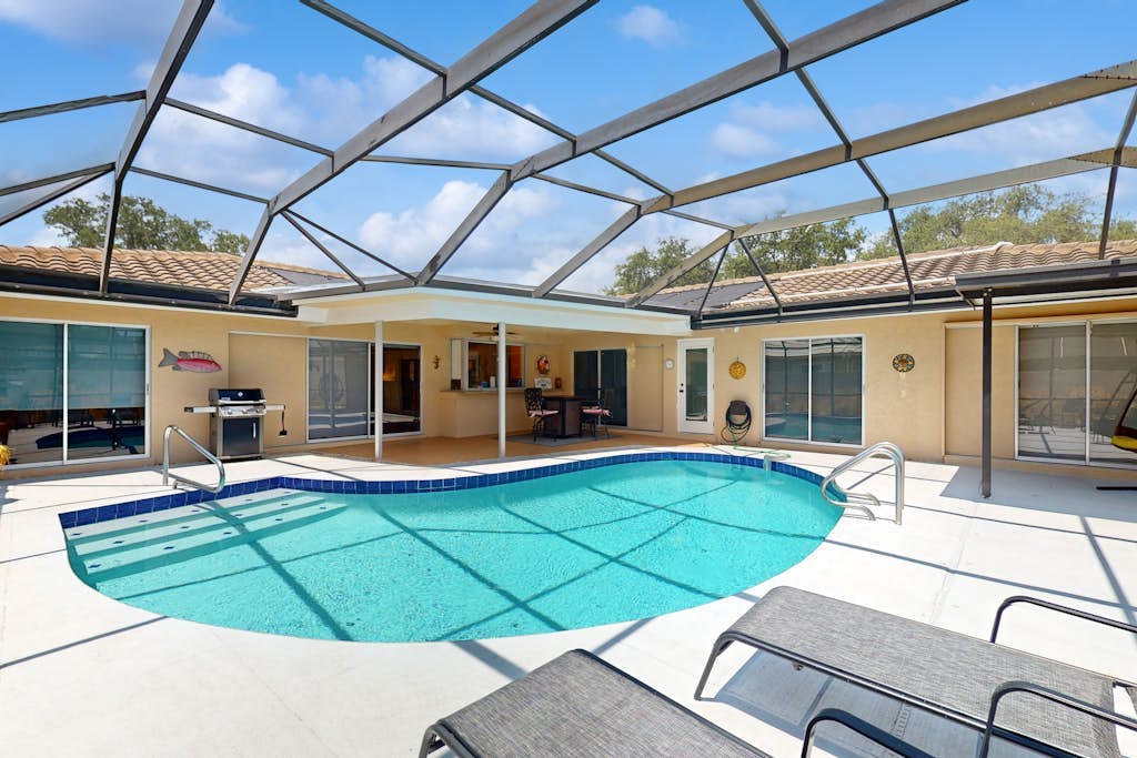 Dog-friendly house with pool, lanai, firepit, grill, patio, & enclosed backyard