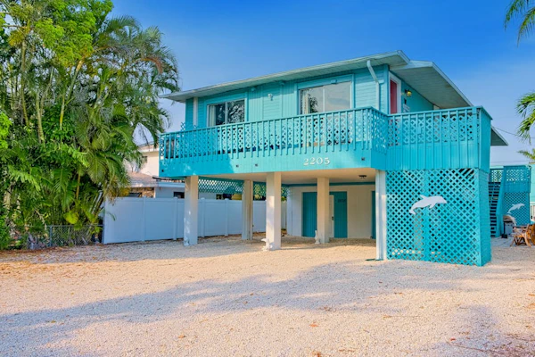 2nd-floor home near beach with heated pool, grill, balcony, & W/D
