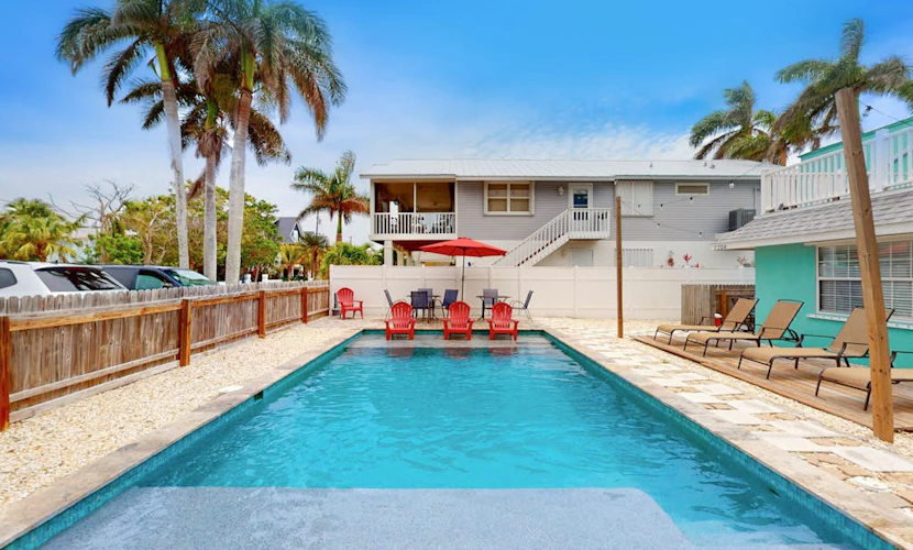 2nd-floor home near beach with heated pool, grill, balcony, & W/D