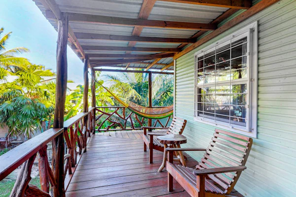 Charming guesthouse with balcony, hammock, WiFi & partial AC - walk to the beach