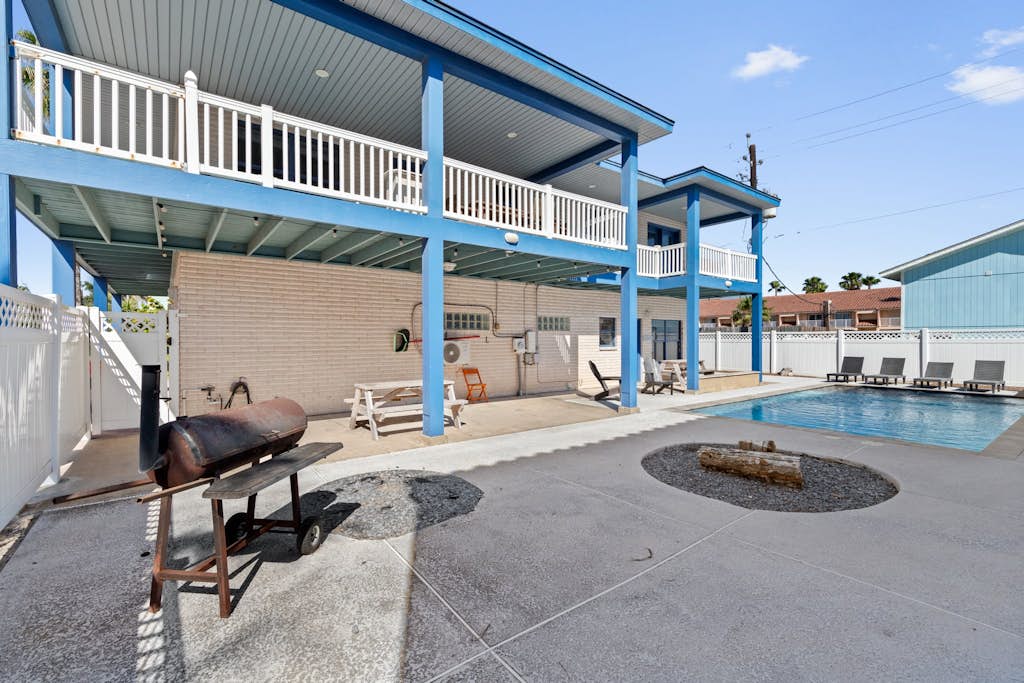 Welcome to Paradise on Padre, a bright two-story island home on the beach side of South Padre with a private fenced pool, a fountain-fed tanning shelf, and the sand a short walk away. Upstairs, an open living, kitchen, and dining space flows to a wrap-around balcony with pool and water views, while a downstairs game room brings foosball, billiards, and a kitchenette. With room for up to 18 guests across three bedrooms, it is made for big families to gather, play, and unwind by the water.