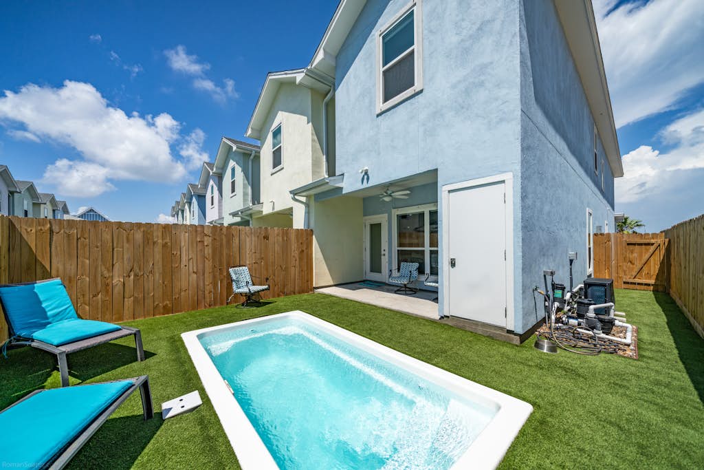Welcome to Endless Sunlight, a bright two-story island retreat in the heart of Padre Isles. Spend sunny afternoons cooling off in your private heated pool, then unwind on the turf patio as the sky lights up at sunset. Inside, an open living and kitchen make gathering easy, while three upstairs bedrooms each feature a smart TV. The primary suite opens to its own balcony with water views. You are just minutes from Whitecap Beach, Padre Balli Park, and Laguna Madre fishing.