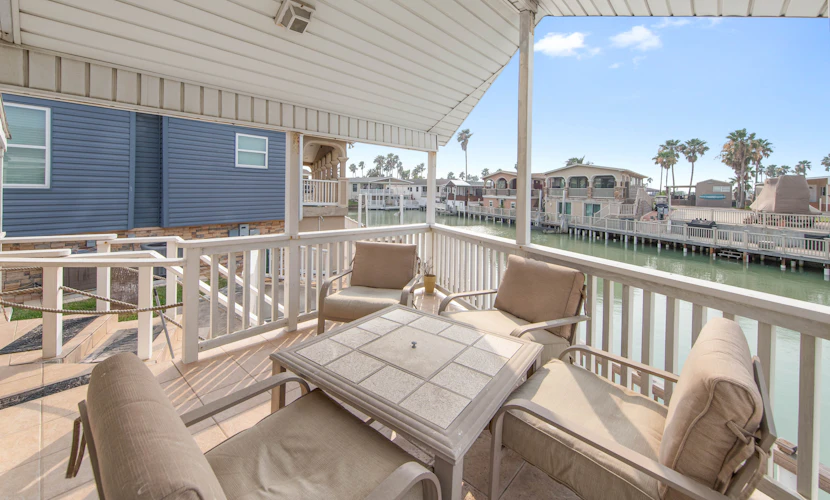 Welcome to Little Breeze, a bright single-level waterfront cottage on a quiet canal in the gated Long Island Village resort near Port Isabel. Sip coffee on the covered deck, take in water views from nearly every window, and settle into a cheerful coastal retreat with a queen bedroom and a living room sleeper sofa. Dive into the resort pools, play the par-3 golf course, or cross the causeway to South Padre Island beaches in minutes. Your easygoing Gulf Coast getaway starts here.
