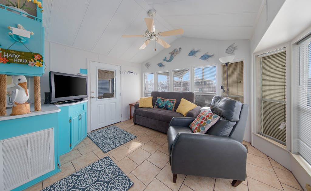 Welcome to Little Breeze, a bright single-level waterfront cottage on a quiet canal in the gated Long Island Village resort near Port Isabel. Sip coffee on the covered deck, take in water views from nearly every window, and settle into a cheerful coastal retreat with a queen bedroom and a living room sleeper sofa. Dive into the resort pools, play the par-3 golf course, or cross the causeway to South Padre Island beaches in minutes. Your easygoing Gulf Coast getaway starts here.